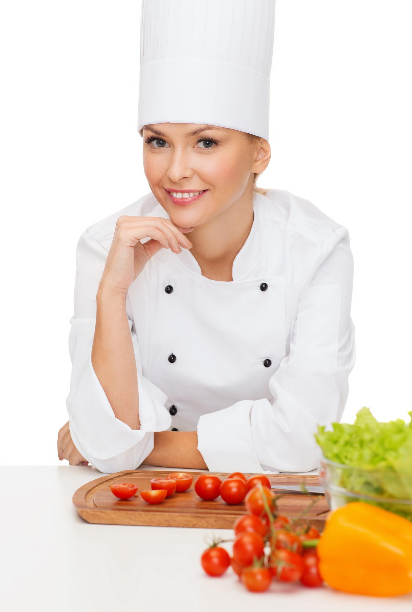 Female chef smiling in kitchen